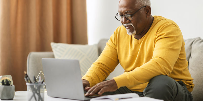 An older man at a computer.